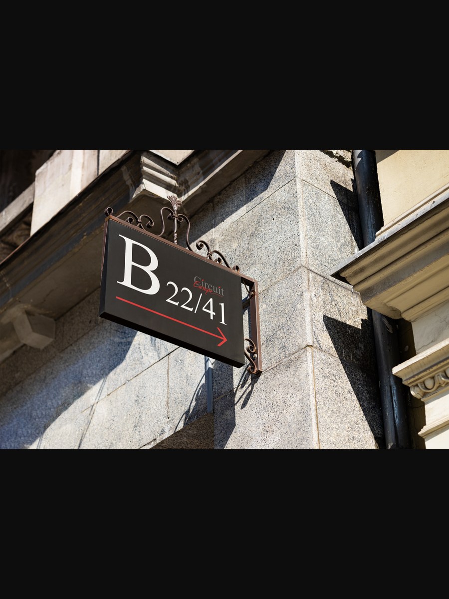 Ornate wall-mounted directional sign