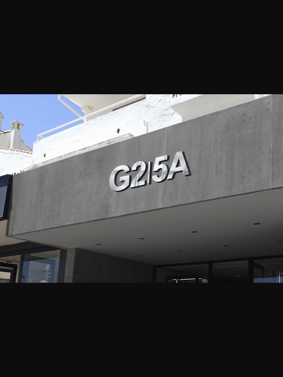 Building identification sign on concrete canopy