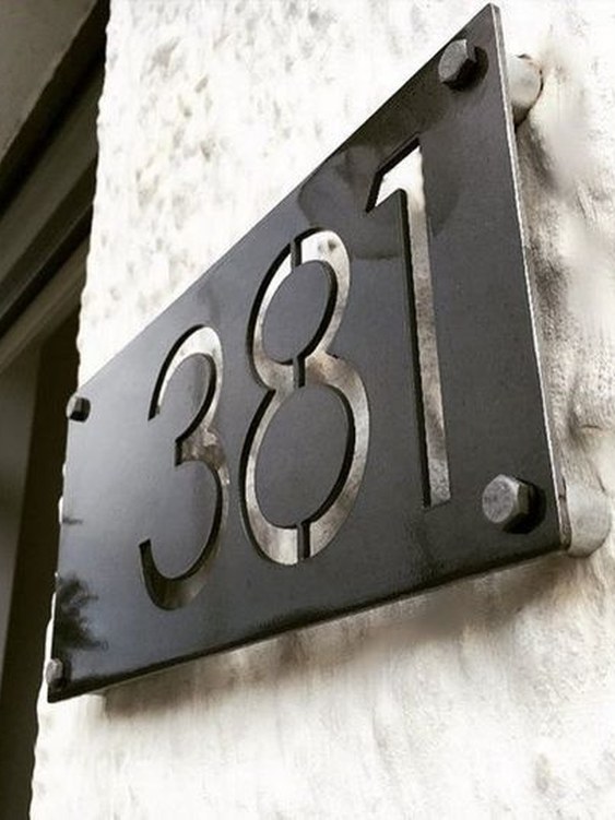 Cast metal unit number on stone